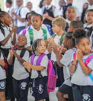 Group of happy students wearing backpacks