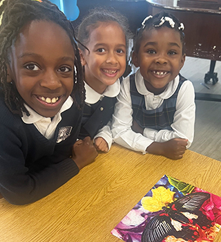 Three proud students with their Spelling Bee awards