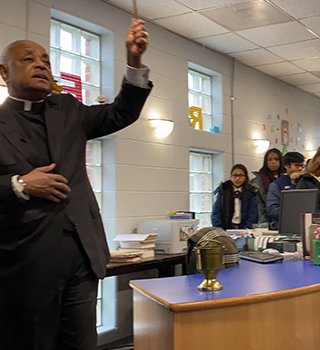 Arch Bishop talking with students