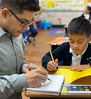 Art teacher working with student